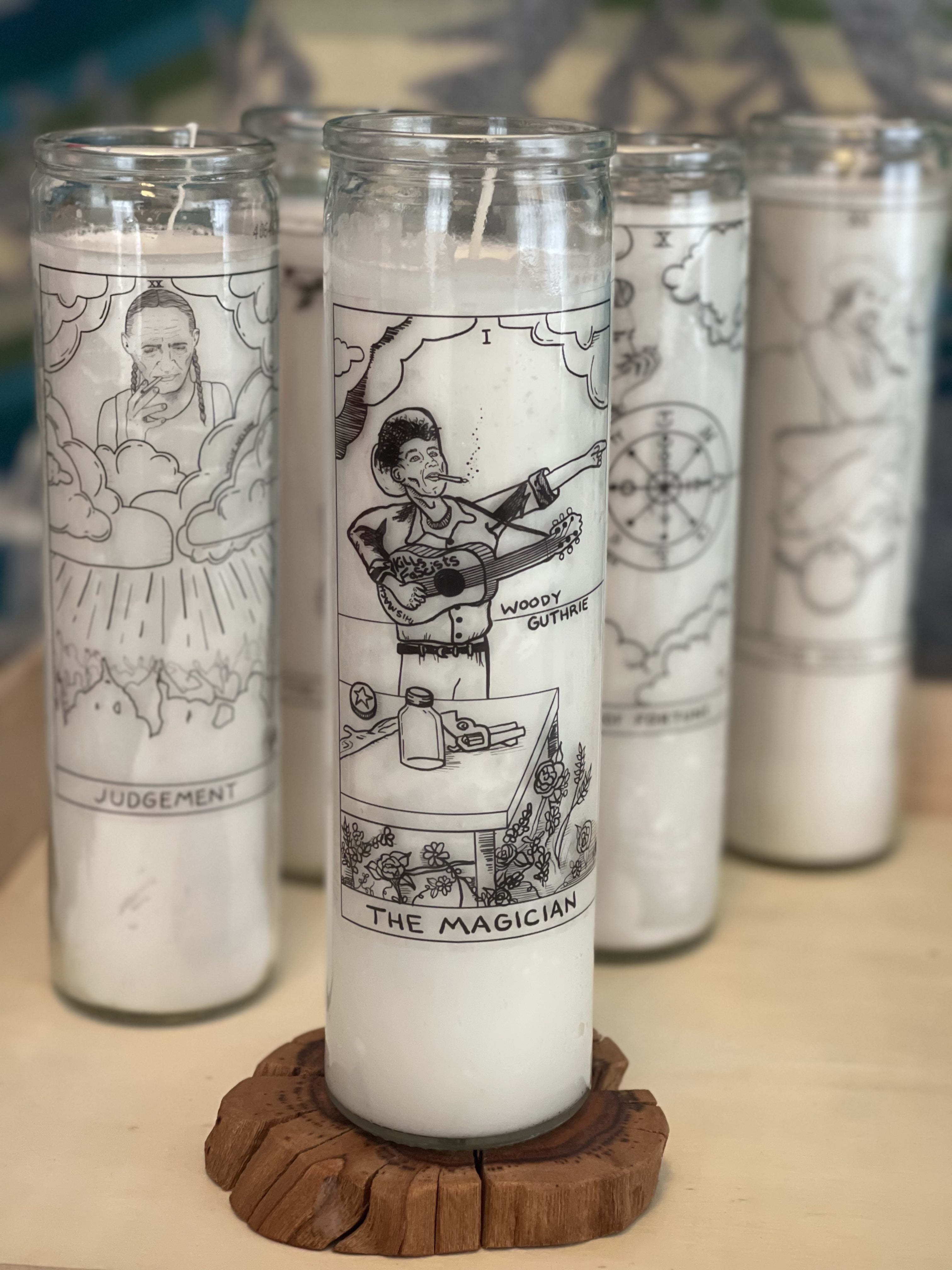 Woody Guthrie as The Magician on a prayer candle with black and white folk art illustration from The Outlaw Oracle's Honky Tonk Tarot Collection.